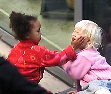 220px-Child_touching_another_childs_face.jpg